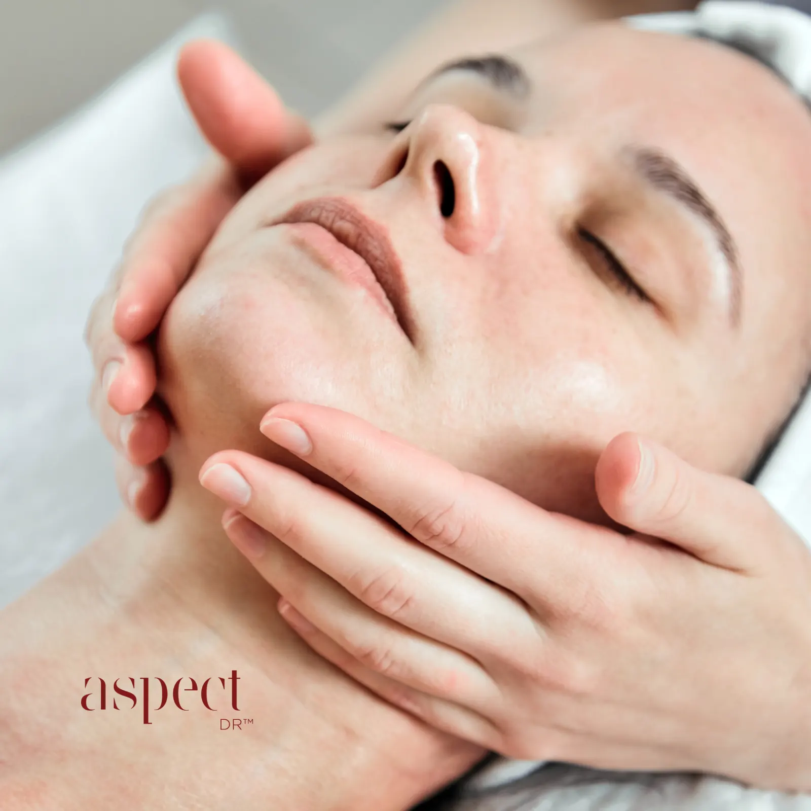 Therapist applying probiotic hydrating facial treatment with serums